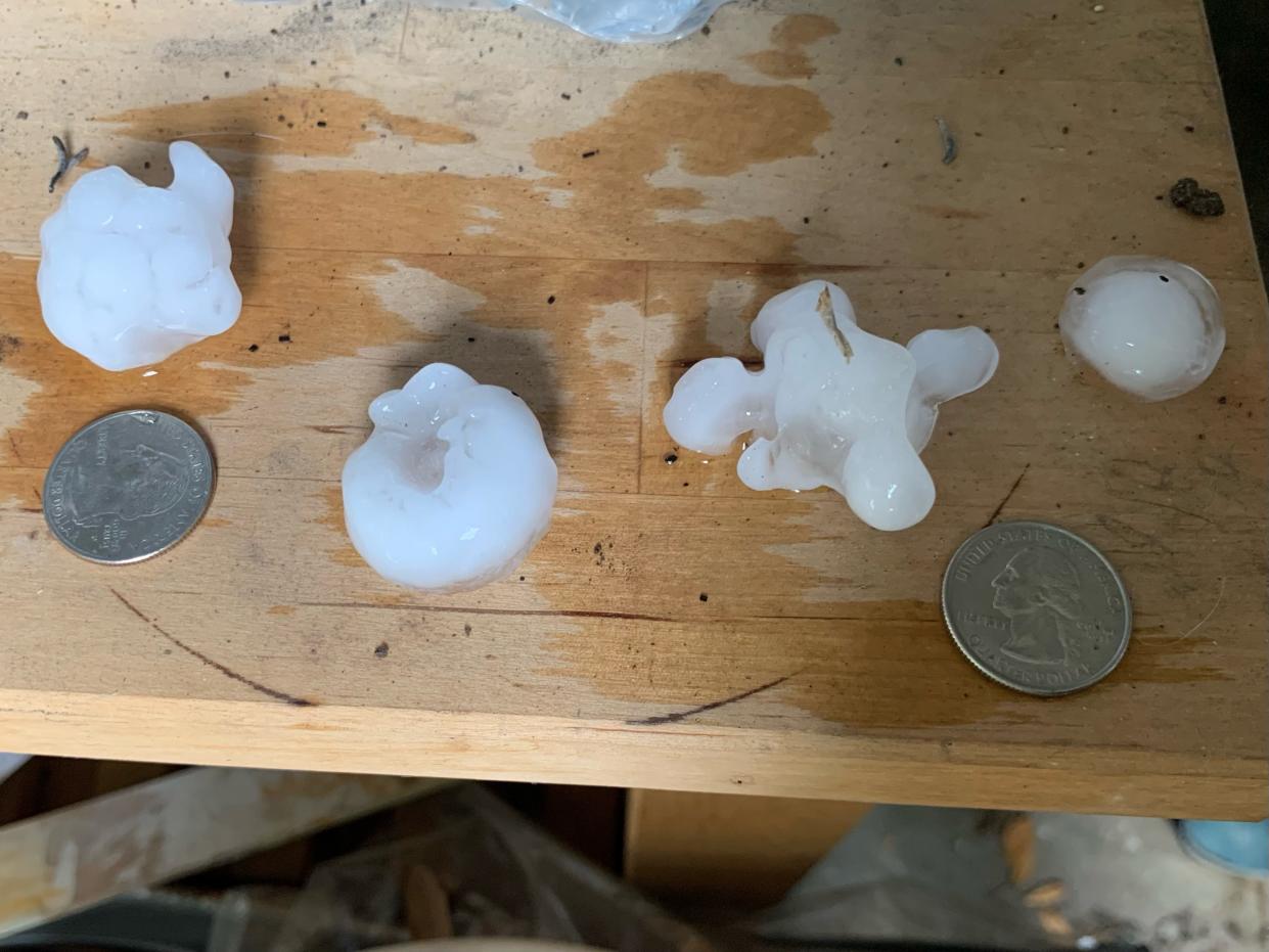 Colby Gordon shows the sizes of hail in Allandale Tuesday afternoon, April 9, 2024.