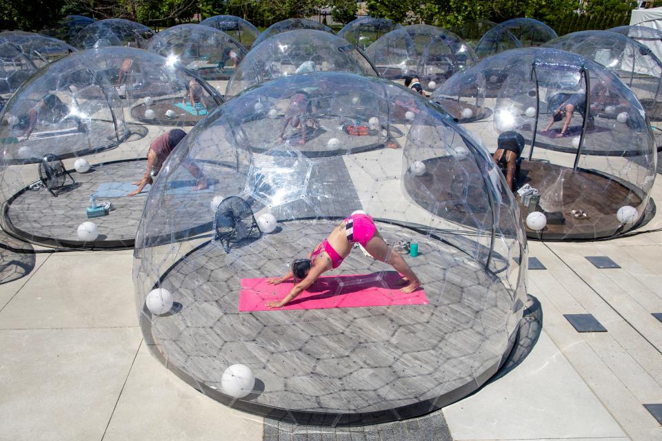 People participate in an outdoor yoga class by LMNTS Outdoor Studio, in a dome to facilitate social distancing and proper protocols to prevent the spread of coronavirus disease (COVID-19), in Toronto, Ontario, Canada June 21, 2020.