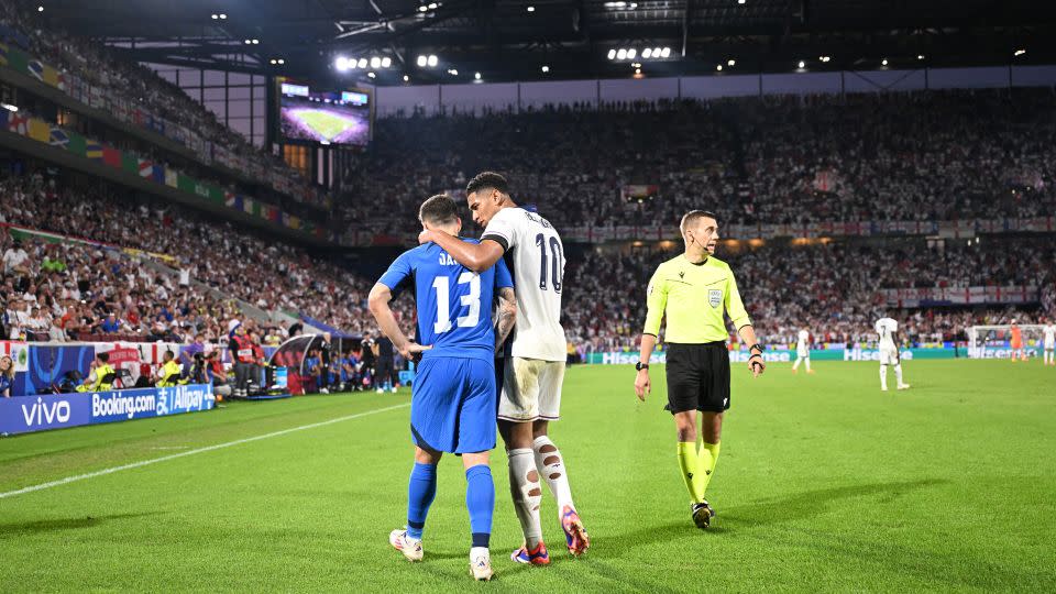 Slovenia defender Erik Janza and England midfielder Jude Bellingham chatting during the match. - Kirill Kudryavtsev/AFP/Getty Images