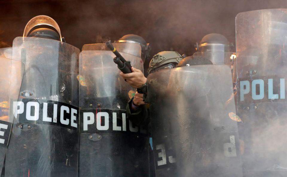 A police officer fires rubber bullets at protesters during a demonstration next to the city of Miami Police Department on May 30. Anti-racist protests were held throughout the country, sparked by the death of George Floyd, a Black man who was killed by Minneapolis police. (ASSOCIATED PRESS)