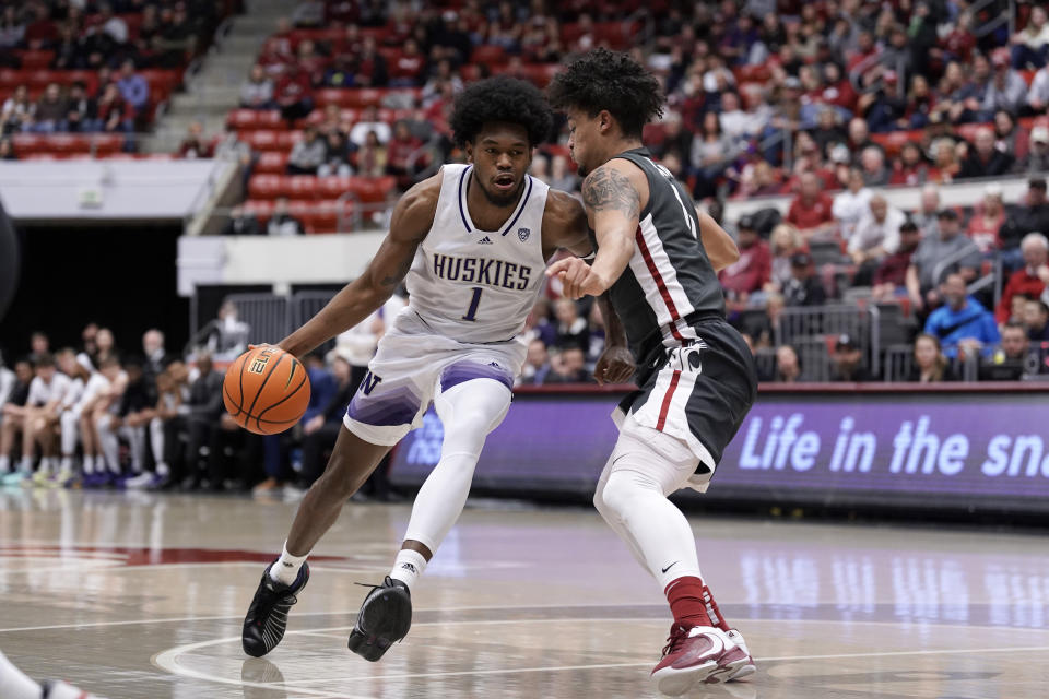 File - Washington forward Keion Brooks Jr. (1) drives against Washington State forward DJ Rodman during the first half of an NCAA college basketball game Feb. 11, 2023, in Pullman, Wash. Brooks averaged 17.7 points per game last season in his first season with the Huskies after starting his career at Kentucky. (AP Photo/Dean Hare, File)