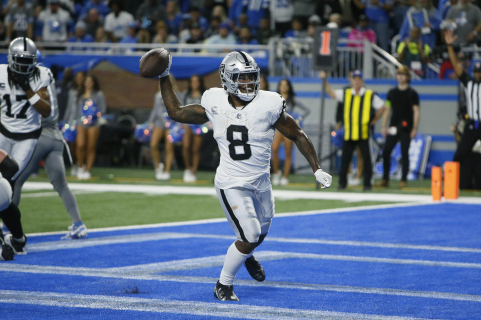 Las Vegas Raiders running back Josh Jacobs (8) throws the ball into the stands afer his three-yard rushing touchdown during the first half of an NFL football game against the Detroit Lions, Monday, Oct. 30, 2023, in Detroit. (AP Photo/Duane Burleson)