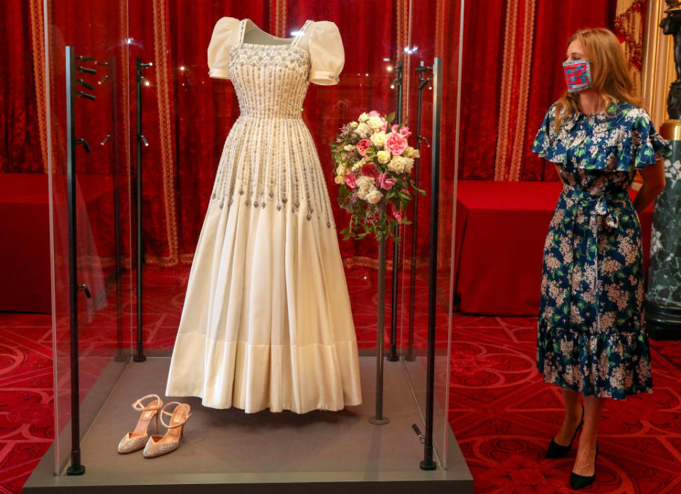 Princess Beatrice admires her vintage wedding dress, now on display at Windsor Castle. (Getty Images) 