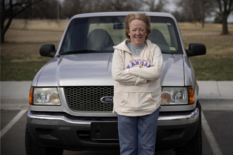 Carol Rice stands with her recently-purchased 2003 Ford Ranger Wednesday, March 15, 2023, in Shawnee, Kan. Rice's timing to buy the truck was ideal, taking advantage of a recent dip in used car prices which now appear to be heading back up. (AP Photo/Charlie Riedel)