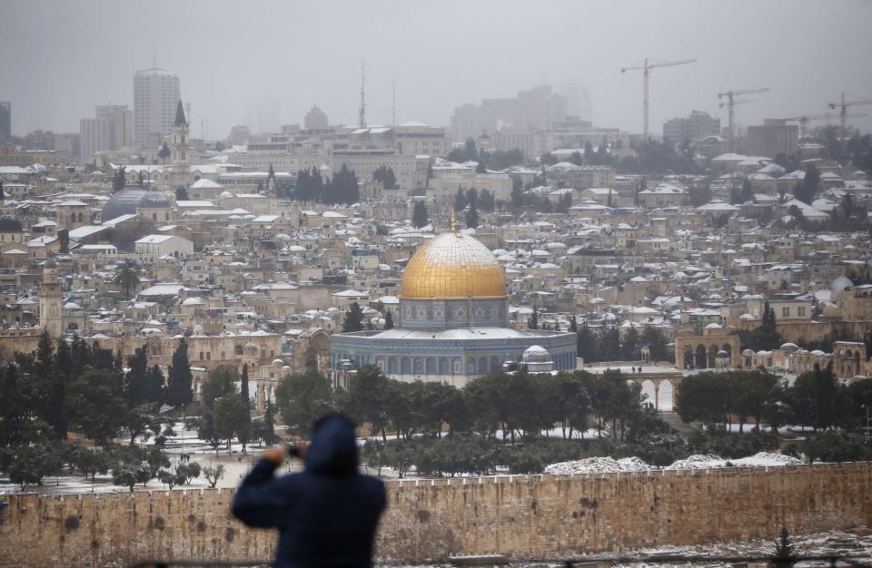 The snow capped Dome of the Rock in the compound known to Muslims as Noble Sanctuary and to Jews as Temple Mount, in Jerusalem's Old City, is seen from the Mount of Olives December 12, 2013. Schools and offices in Jerusalem and parts of the occupied West Bank were widely closed and public transport paused after heavy snowfall on Thursday. REUTERS/Darren Whiteside (JERUSALEM - Tags: ENVIRONMENT RELIGION)