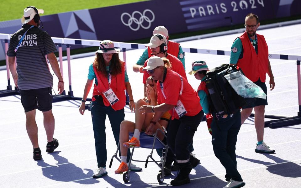 Germany's Sophie Weissenberg is taken on a wheelchair ahead of the women's heptathlon 100m hurdles