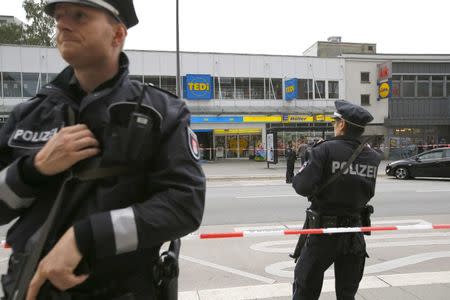 Police officers look on after a knife attack in a supermarket in Hamburg, Germany, July 28, 2017. REUTERS/Morris Mac Matzen