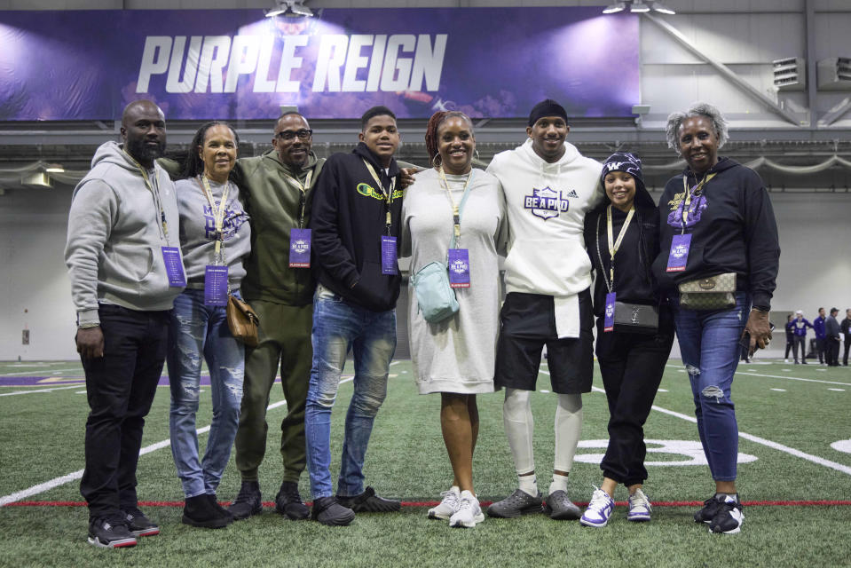 Washington quarterback Michael Penix Jr., third from right, poses with family and friends after the team's NFL football pro day Thursday, March 28, 2024, in Seattle. (AP Photo/John Froschauer)