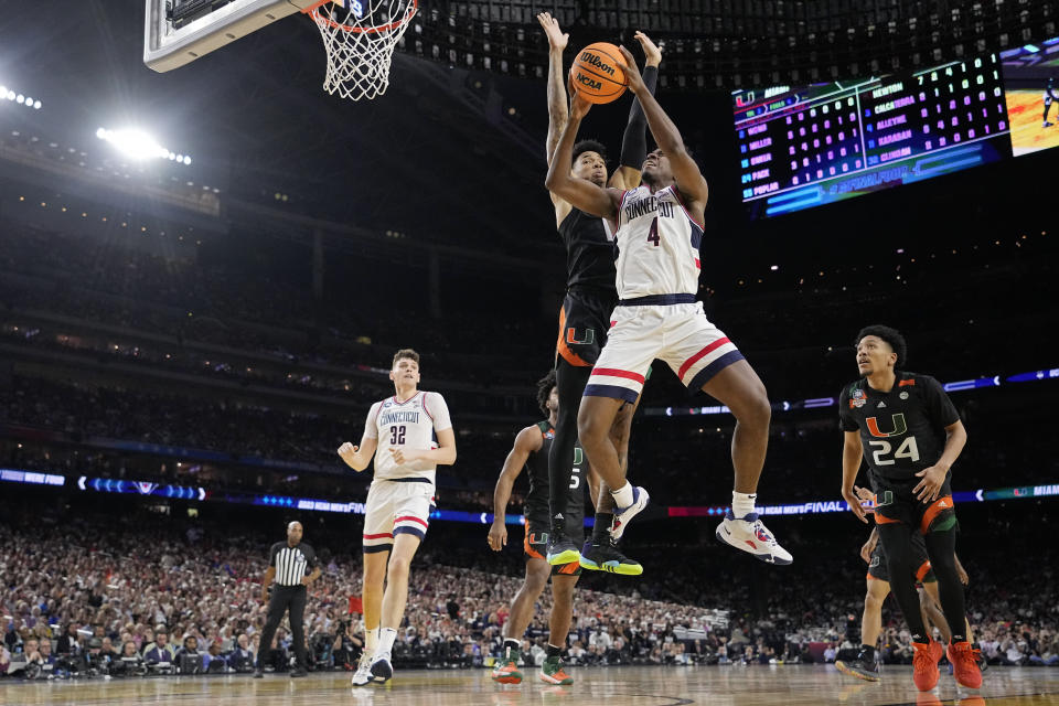 Connecticut guard Nahiem Alleyne drives to the basket past Miami guard Jordan Miller during the first half of a Final Four college basketball game in the NCAA Tournament on Saturday, April 1, 2023, in Houston. (AP Photo/Brynn Anderson)