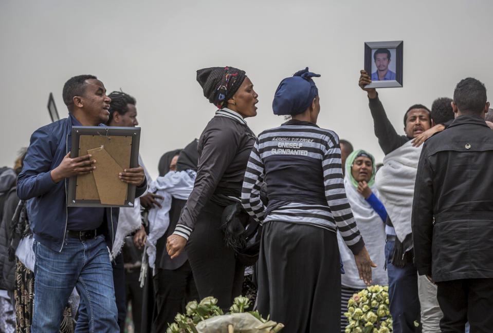 Ethiopian relatives of crash victims mourn at the scene where the Ethiopian Airlines Boeing 737 Max 8 crashed shortly after takeoff on Sunday killing all 157 on board, near Bishoftu, south-east of Addis Ababa, in Ethiopia Thursday, March 14, 2019. About 200 family members of people who died on the crashed jet stormed out of a briefing with Ethiopian Airlines officials in Addis Ababa on Thursday, complaining that the airline has not given them adequate information. (AP Photo/Mulugeta Ayene)