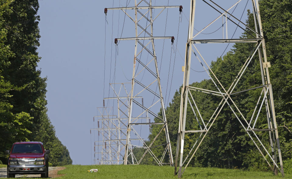 FILE - Power transmission lines deliver electricity to rural Orange County on Aug. 14, 2018, near Hillsborough, N.C. Investigators believe a shooting Saturday, Dec. 3, 2022, that damaged power substations in North Carolina was a crime. The shooting serves as a reminder for why experts have stressed the need to secure the U.S. power grid. Authorities have warned that the nation's electricity infrastructure could be vulnerable targets for domestic terrorists. (AP Photo/Gerry Broome, File)
