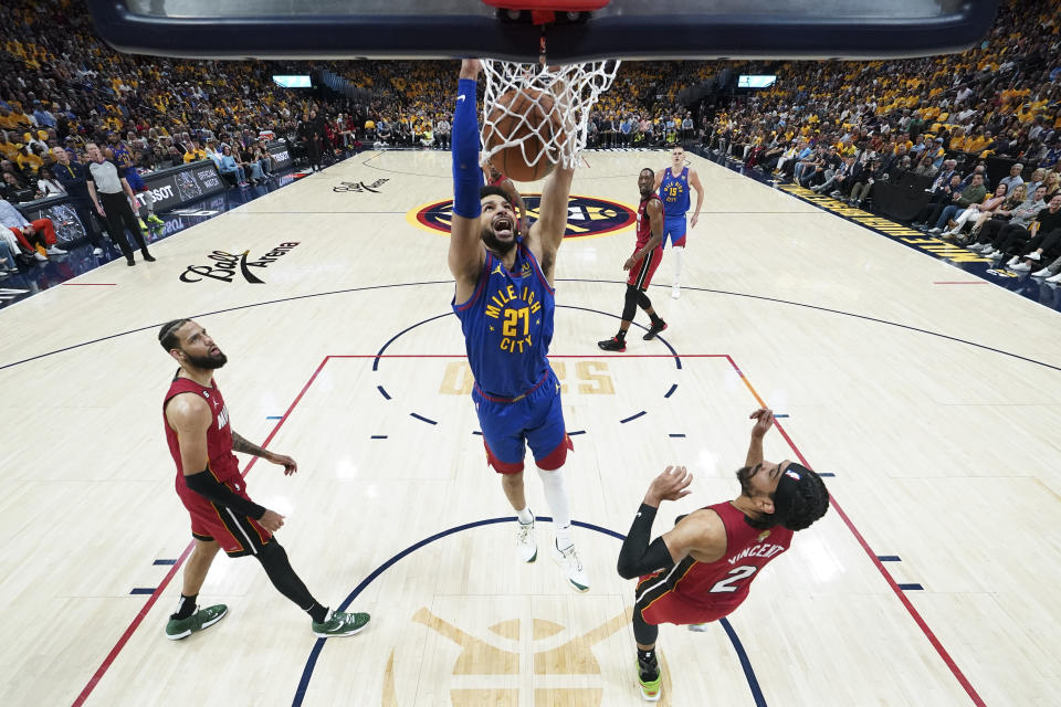 Denver Nuggets guard Jamal Murray (27) dunks against the Miami Heat during the first half of Game 1 of basketball's NBA Finals, Thursday, June 1, 2023, in Denver. (Kyle Terada/Pool Photo via AP)