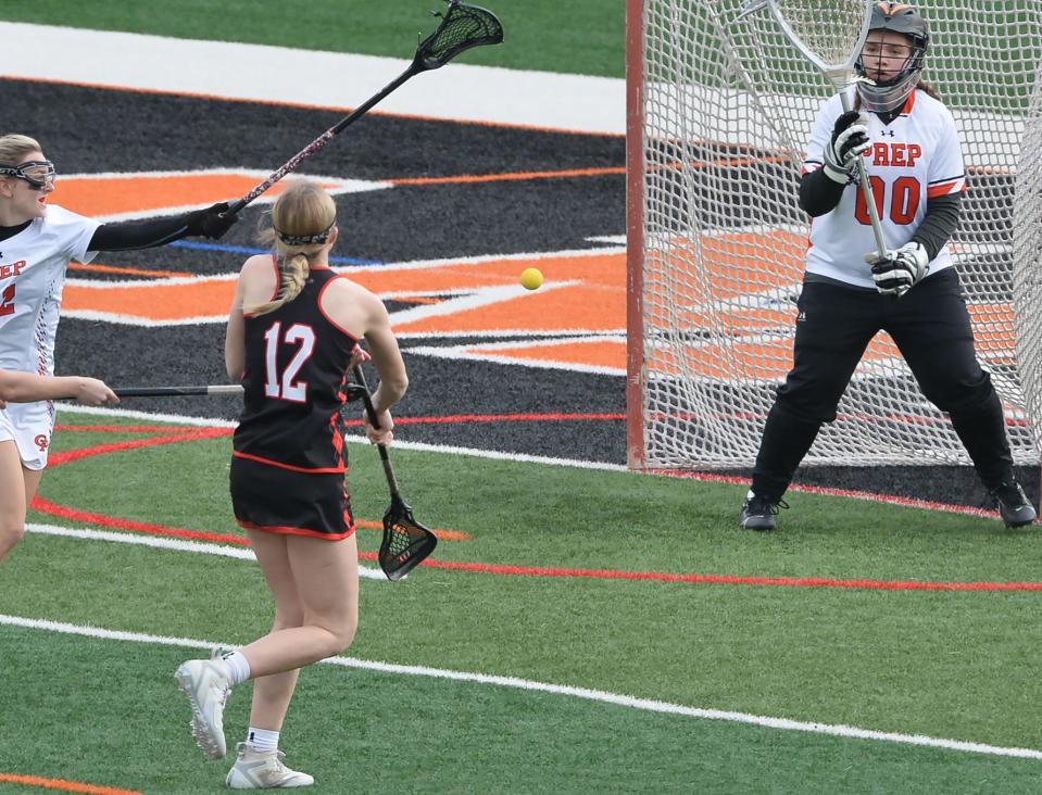 Fairview High School's Kiley Leasure (12) scores past Cathedral Prep goalkeeper Allison Deiner during a girls lacrosse game at Dollinger Field, Hagerty Family Events Center, in Erie on May 4, 2023.