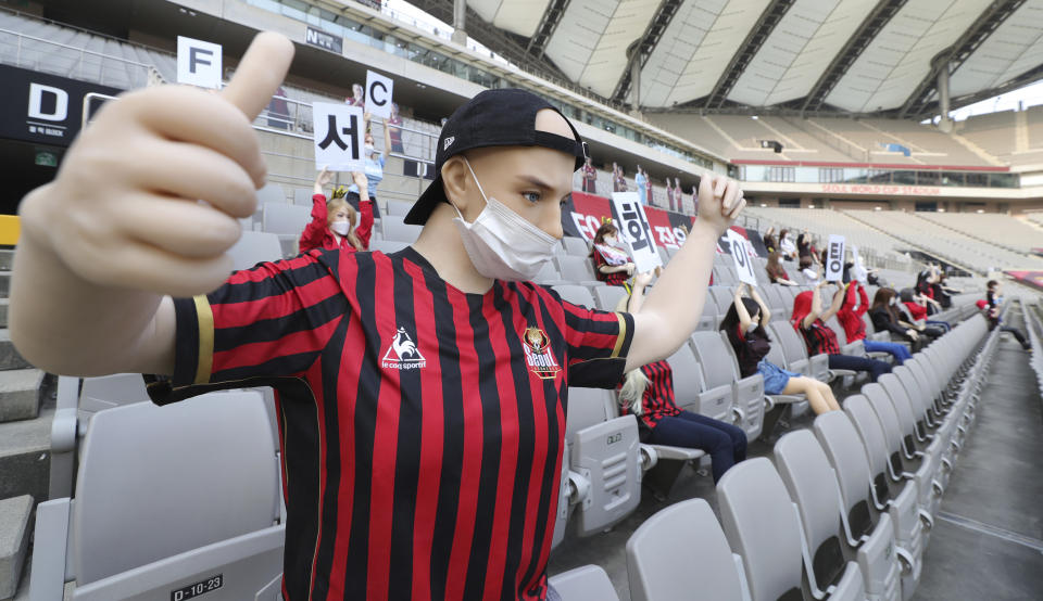 In this May 17, 2020 photo, cheering mannequins are installed at the empty spectators&#39; seats before the start of a soccer match between FC Seoul and Gwangju FC at the Seoul World Cup Stadium in Seoul, South Korea. A South Korean professional soccer club has apologized after being accused of putting sex dolls in empty stands during a match Sunday in Seoul. In a statement, FC Seoul expressed &quot;sincere remorse&quot; over the controversy, but insisted that it used mannequins, not sex dolls, to mimic a home crowd during its 1-0 win over Gwangju FC at the Seoul World Cup stadium. (Ryu Young-suk/Yonhap via AP)