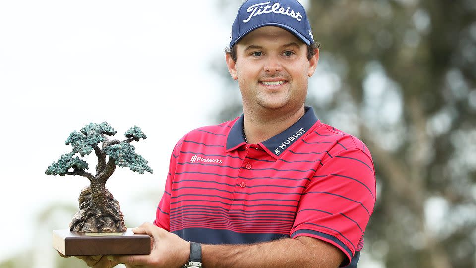 Seen here, Patrick Reed holds the Farmers Insurance Open trophy aloft.