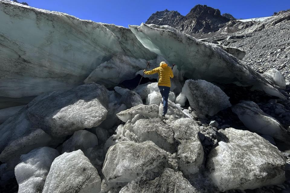 FILE - Glaciologist Andrea Fischer from the Austrian Academy of Sciences climbs up at the Jamtalferner Glacier near Galtuer, Austria, on Sept. 6, 2023. Austrian glaciers receded last year at a rapid pace, and the Alpine country is likely to be largely ice-free in 40 to 45 years as the process continues, experts said Friday April 5, 2024. (AP Photo/Matthias Schrader, File)