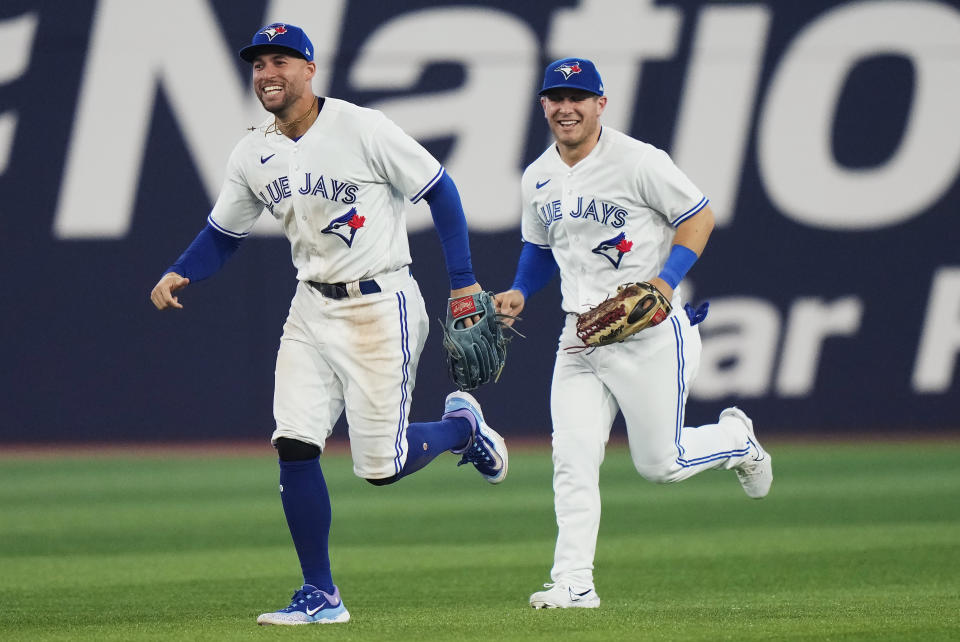 Toronto Blue Jays right fielder George Springer (4) and center fielder Daulton Varsho (25) celebrate after defeating the San Francisco Giants in a baseball game in Toronto, on Wednesday, June 28, 2023. (Frank Gunn/The Canadian Press via AP)