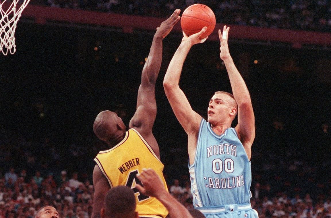 5 APR 1993:  University of North Carolina center Eric Montross (00) jumps up for the shot as University of Michigan forward Chris Webber (4) tries to block during the NCAA Photos via Getty Images National Basketball Championship game at the Superdome in New Orleans, LA. North Carolina defeated Michigan 77-71 for the championship title.