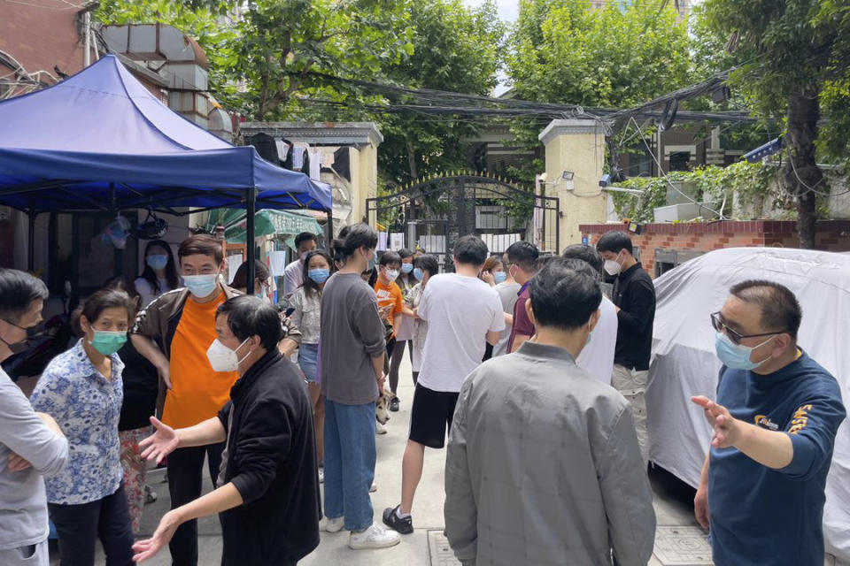 Residents gather near the entrance of their compound to demand clarity on when their residential compound would open up in Jingan district in Shanghai on May 25, 2022. Residents in China's largest city of Shanghai have become bolder in demanding the lifting or easing of coronavirus restrictions that have left millions locked up in their compounds for almost two months. (AP Photo)