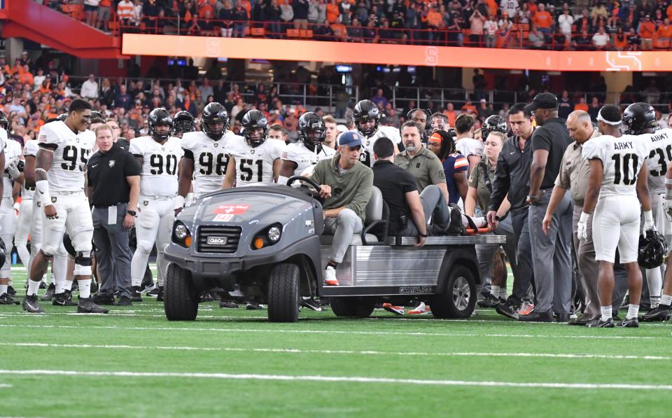 army defensive lineman Dre Miller is carted off the field as his teammates gather around him in the fourth quarter game against Syracuse at the JMA Wireless Dome. Mandatory Credit: Mark Konezny-USA TODAY Sports