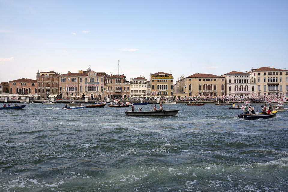 "No Big Ships" activists stage a protest as the MSC Orchestra cruise ship leaves Venice, Italy, Saturday, June 5, 2021. The 92,409-ton, 16-deck MSC Orchestra cruise ship, the first cruise ship leaving Venice since the pandemic is set to depart Saturday amid protests by activists demanding that the enormous ships be permanently rerouted out the fragile lagoon, especially Giudecca Canal through the city's historic center, due to environmental and safety risks. The ship passed two groups of protesters: pro-cruise advocates whose jobs depend on the industry as well as protesters who have been campaigning for years to get cruise ships out of the lagoon. (AP Photo/Antonio Calanni)