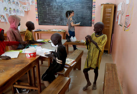 Moussa, a Koran student, called a talibe, from Futa, stands inside a classroom of Maison de la Gare, an organisation that helps talibe street children reintegrate into society, in Saint-Louis, Senegal, February 7, 2019. REUTERS/Zohra Bensemra