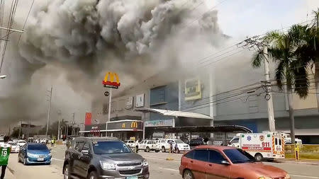 Smoke rises from burning mall's 3rd floor, in Davao City, Philippines, in this December 23, 2017 picture obtained from social media. Courtesy Otto van Dacula via REUTERS