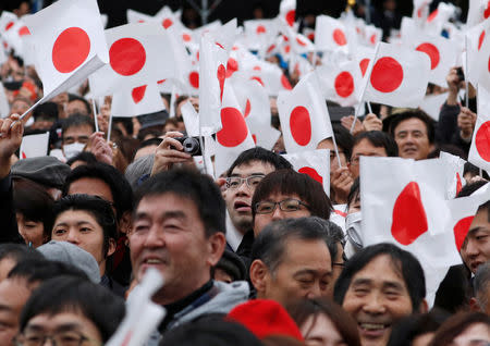 Well-wishers wave Japanese national flags as Japan's Emperor Akihito (not pictured) appears on a balcony of the Imperial Palace to celebrate his 85th birthday in Tokyo, Japan, December 23, 2018. REUTERS/Issei KatoREUTERS/Issei Kato