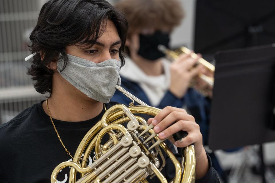 Students play instruments with face masks in a band class at Churchill High School in Livonia on Jan. 22, 2021.