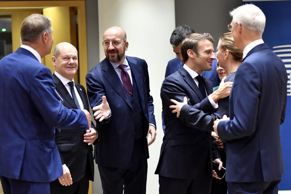 From left, Romania's President Klaus Werner Ioannis, Germany's Chancellor Olaf Scholz, European Council President Charles Michel, Spain's Prime Minister Pedro Sanchez, France's President Emmanuel Macron, Denmark's Prime Minister Mette Frederiksen and Latvia's Prime Minister Krisjanis Karins during a round table meeting at an EU summit in Brussels, Friday, Oct. 21, 2022. European Union leaders gathered Friday to take stock of their support for Ukraine after President Volodymyr Zelenskyy warned that Russia is trying to spark a refugee exodus by destroying his war-ravaged country's energy infrastructure. (AP Photo/Geert Vanden Wijngaert)