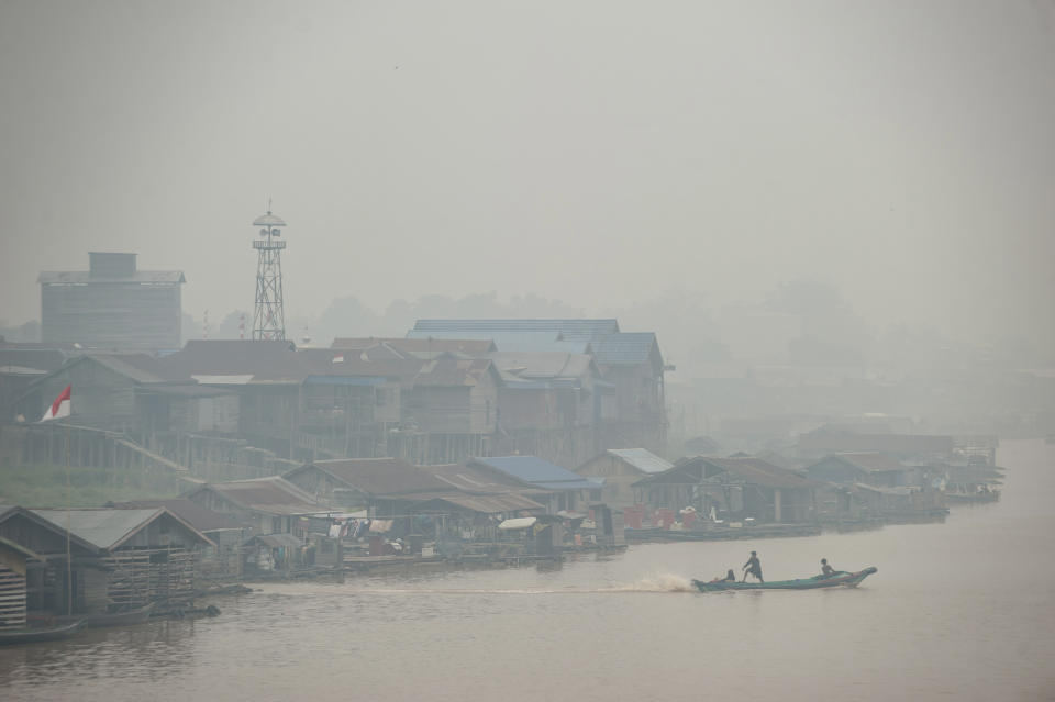 Haze from forest fires blankets villages along Kahayan river in Palangkaraya, Central Kalimantan, Indonesia, Friday, Sept. 20, 2019. Haze blown by monsoon winds from fires in Indonesia has begun affecting some areas of the Philippines and raised concerns about aviation safety and possible health risks, an official said Friday. (AP Photo/Fauzy Chaniago)