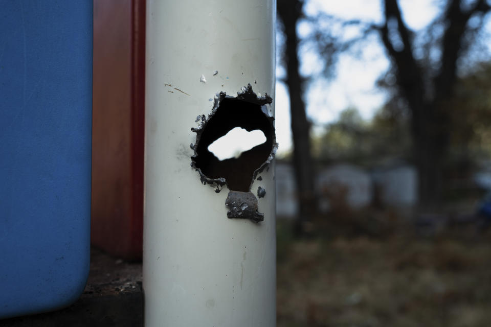 A hole in a steel pipe left by a Russian rocket fragment, in a playground after a Russian rocket attack, in Kyiv, Ukraine, Thursday, Sept. 21, 2023. (AP Photo/Roman Hrytsyna)