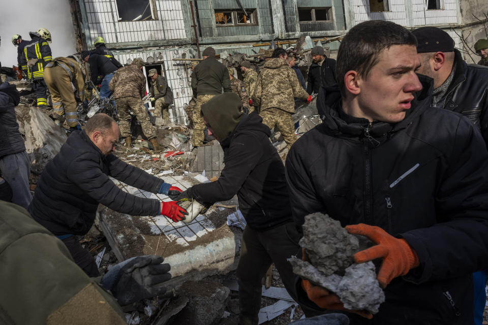 Following a Russian attack, first responders remove rubble at a residential building in Uman, central Ukraine, Friday, April 28, 2023. (AP Photo/Bernat Armangue)