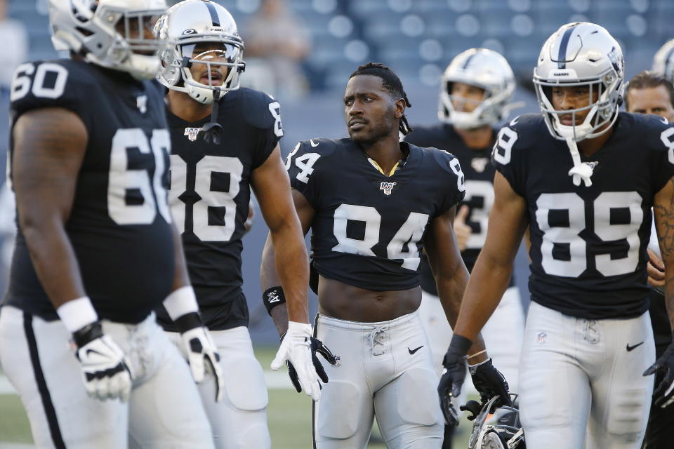 Oakland Raiders' Antonio Brown (84) and teammates gather before an NFL preseason football game against the Green Bay Packers on Thursday, Aug. 22, 2019, in Winnipeg, Manitoba. (John Woods/The Canadian Press via AP)
