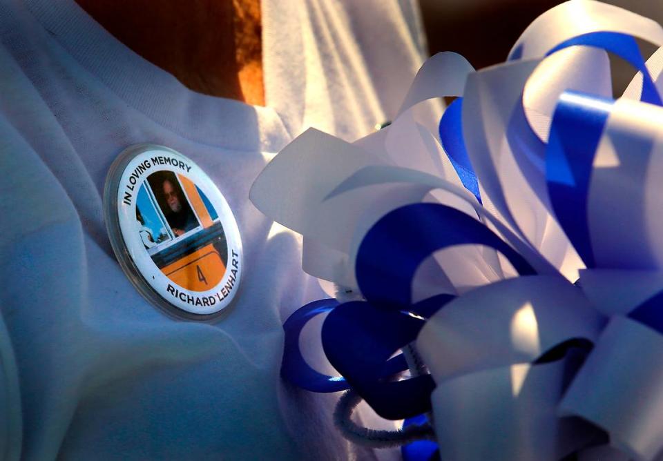 Nancy Lenhart, the widow of bus driver Richard L. Lenhart, wears a button in honor of her husband at the the 2023 grand opening of the Pasco School District’s new transportation center named in honor of the slain bus driver.