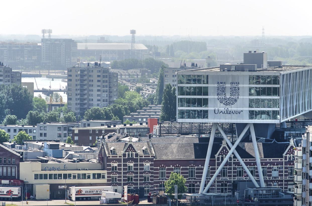 Rotterdam, The Netherlands, June 3, 2018: Unilever office The Bridge. constructed on top of a factory in neighbourhood Feijenoord; stadium of footbal club Feyenoord in the background