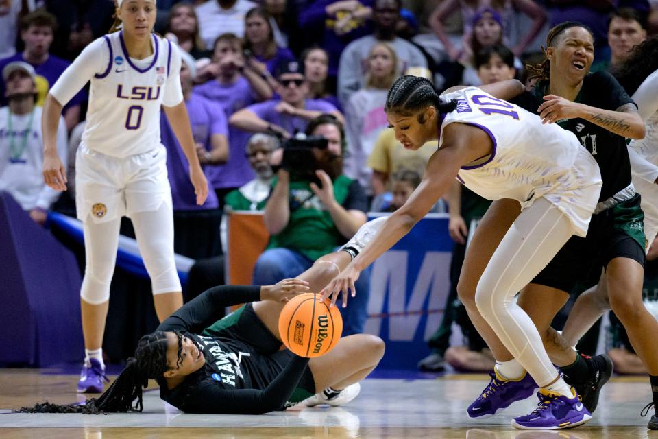 LSU forward Angel Reese (10) steals the ball from Hawaii forward Nnenna Orji during the second half of a first-round college basketball game in the women's NCAA Tournament in Baton Rouge, La., Friday, March 17, 2023. (AP Photo/Matthew Hinton)
