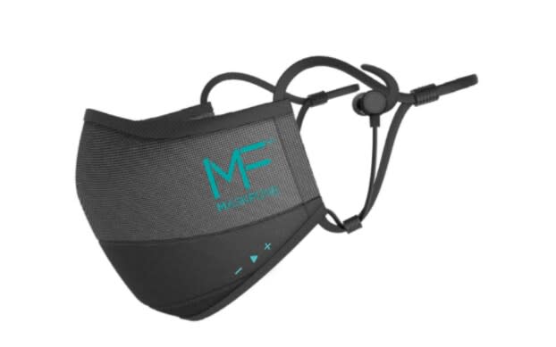 The Maskfone, a black face mask with earbuds attached and teal green volume and music controls on the lower hem of the mask - Maskfone