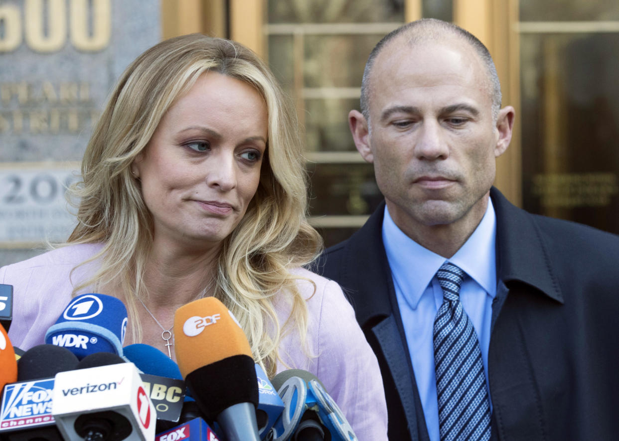 FILE- Adult film actress Stormy Daniels, accompanied by her attorney, Michael Avenatti, right, talks to the media as she leaves federal court, on April 16, 2018 in New York. Avenatti, the once high-profile California attorney who regularly taunted then-President Donald Trump during frequent television appearances, was introduced Thursday, Jan. 20, 2022, to prospective jurors who will decide whether he cheated porn star Stormy Daniels out of book-deal proceeds. (AP Photo/Mary Altaffer, File)