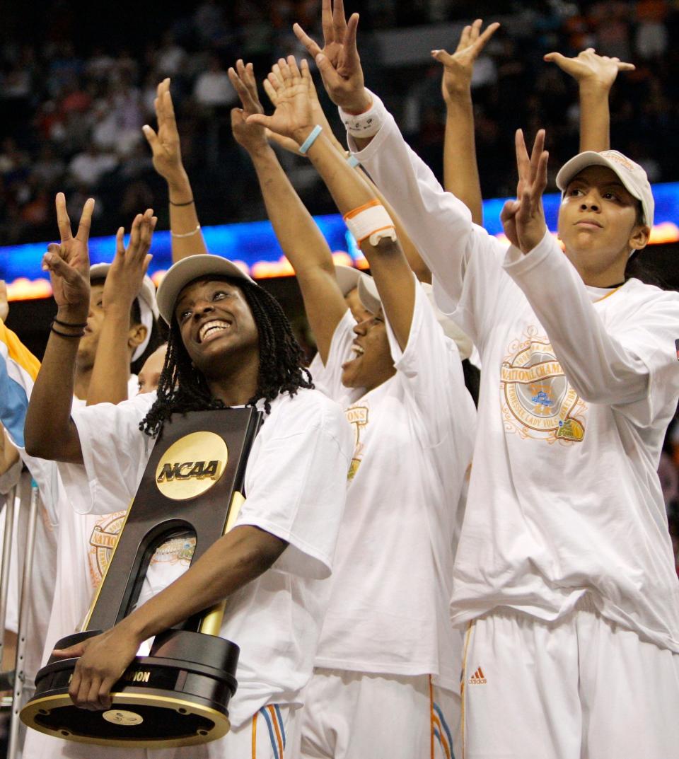 FILE - Tennessee's Vicki Baugh holds the trophy as she and her teammates celebrate their 64-48 win over Stanford in the championship game at the Final Four in the NCAA women's basketball tournament in Tampa, Fla., April 8, 2008. Candace Parker, right, holds up eight fingers to signify the school's eighth women's basketball championship. (AP Photo/Gerry Broome/FILE)