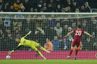 Liverpool's Diogo Jota, right, scores the winning penalty past Leicester's goalkeeper Kasper Schmeichel of the penalty shootout of the English League Cup quarter-final soccer match between Liverpool and Leicester City, at Anfield Stadium, in Liverpool, England, Wednesday Dec. 22, 2021. (AP Photo/Jon Super)