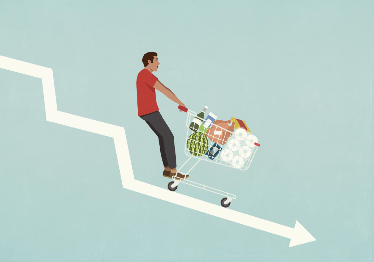  Male consumer with shopping cart of groceries falling down descending arrow. 