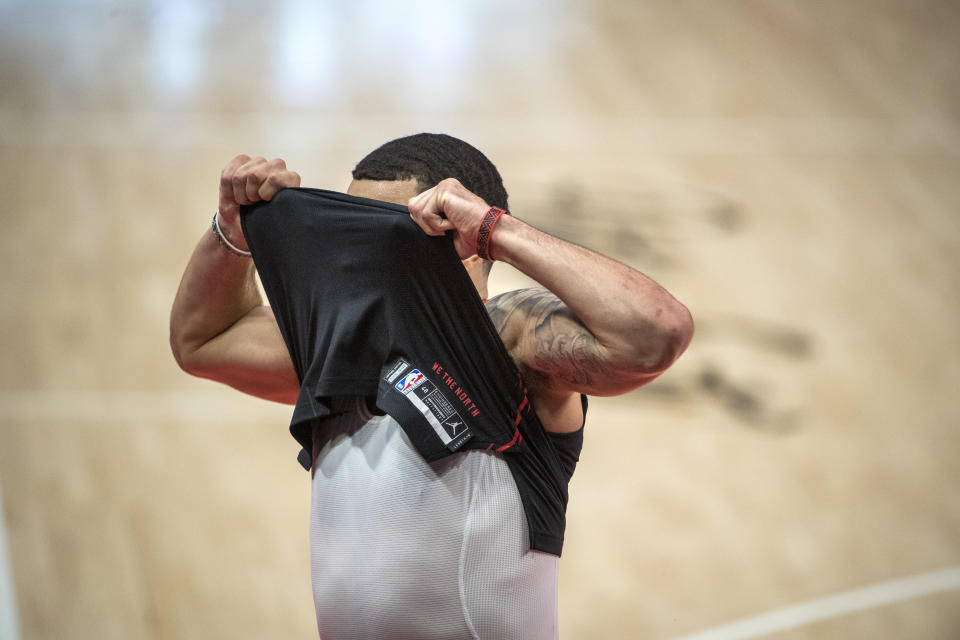 DETROIT, MICHIGAN - MARCH 29: Fred VanVleet #23 of the Toronto Raptors puts his shirt over his face during the second quarter of the game against the Detroit Pistons at Little Caesars Arena on March 29, 2021 in Detroit, Michigan. NOTE TO USER: User expressly acknowledges and agrees that, by downloading and or using this photograph, User is consenting to the terms and conditions of the Getty Images License Agreement. (Photo by Nic Antaya/Getty Images)