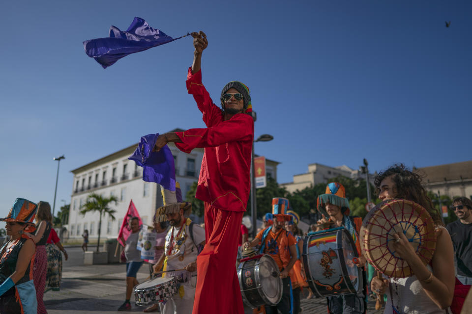 Activists march against the Brazilian government's environmental policies, on the sidelines of the Latin America and Caribbean Climate Week (LACCW) 2019, a meeting on climate change, in Salvador, Brazil, Wednesday, Aug. 21, 2019. Environment Minister Salles was booed Wednesday as he took the stage at the five-day U.N. workshop in Salvador, an event he had tried to cancel earlier this year. (AP Photo/Victor R. Caivano)