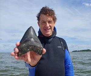 Diver Bill Eberlein with Megaladon tooth