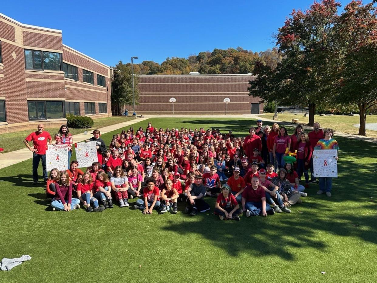 Madison Middle School students met on the lawn posing in red for Red Ribbon Week Oct. 25.