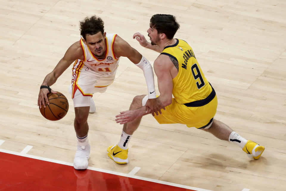 Atlanta Hawks guard Trae Young (11) tries to get around Indiana Pacers guard T.J. McConnell (9) as he brings the ball up during the fourth quarter of an NBA basketball game Saturday, Feb. 13, 2021, in Atlanta. (AP Photo/Butch Dill)