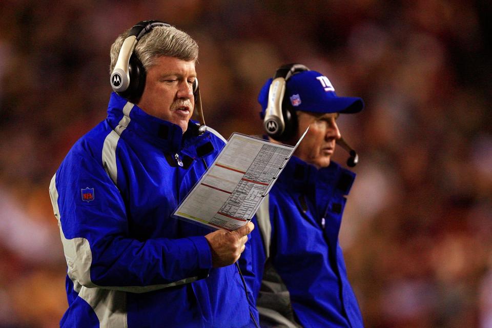 Quarterbacks coach Kevin Gilbride (L) and head coach Tom Coughlin of the New York Giants on the sidelines against the Washington Redskins in 2006. The coaches formed a strong relationship off the field as well, which led to Coughlin hiring Gilbride's son to his staff. (Photo by Jamie Squire/Getty Images)