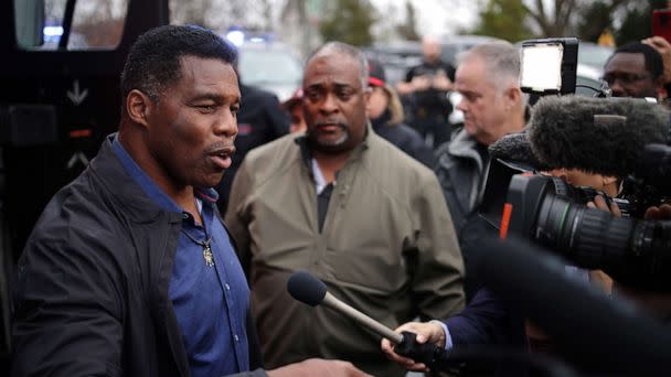 PHOTO: Georgia Republican senate candidate Herschel Walker speaks to members of the press after a campaign stop on Dec. 5, 2022 in Dawsonville, Georgia. (Alex Wong/Getty Images)