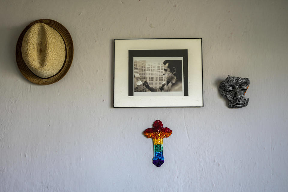 A gay pride motif cross decorates the home of partners Partners Lázaro “Lachi” González and Adiel González in Matanzas, Cuba, Thursday, Oct. 7, 2021. The socialist government recently published a draft Family Law and asked for public comment ahead of a referendum on legalizing same-sex marriage, as well as expanding grandparents rights, allowing for prenuptial agreements and in cases of divorce, create financial consequences for those who have committed gender violence, amid a total of 480 articles. (AP Photo/Ramon Espinosa)